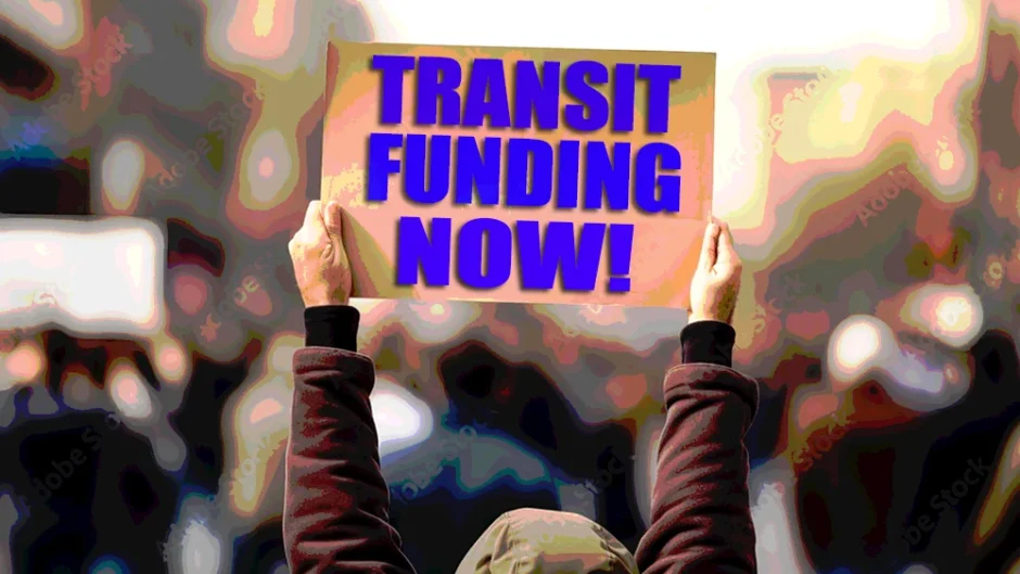 Protester holding up sign that reads "Transit funding now!"